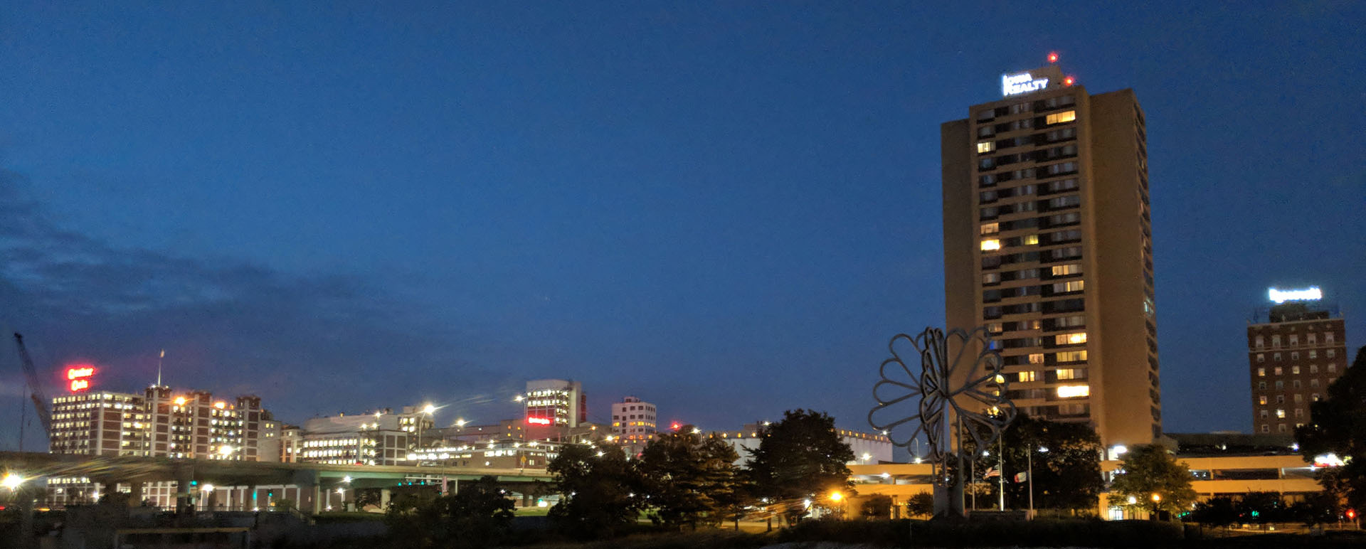 Neon color image of a band playing and people singing along